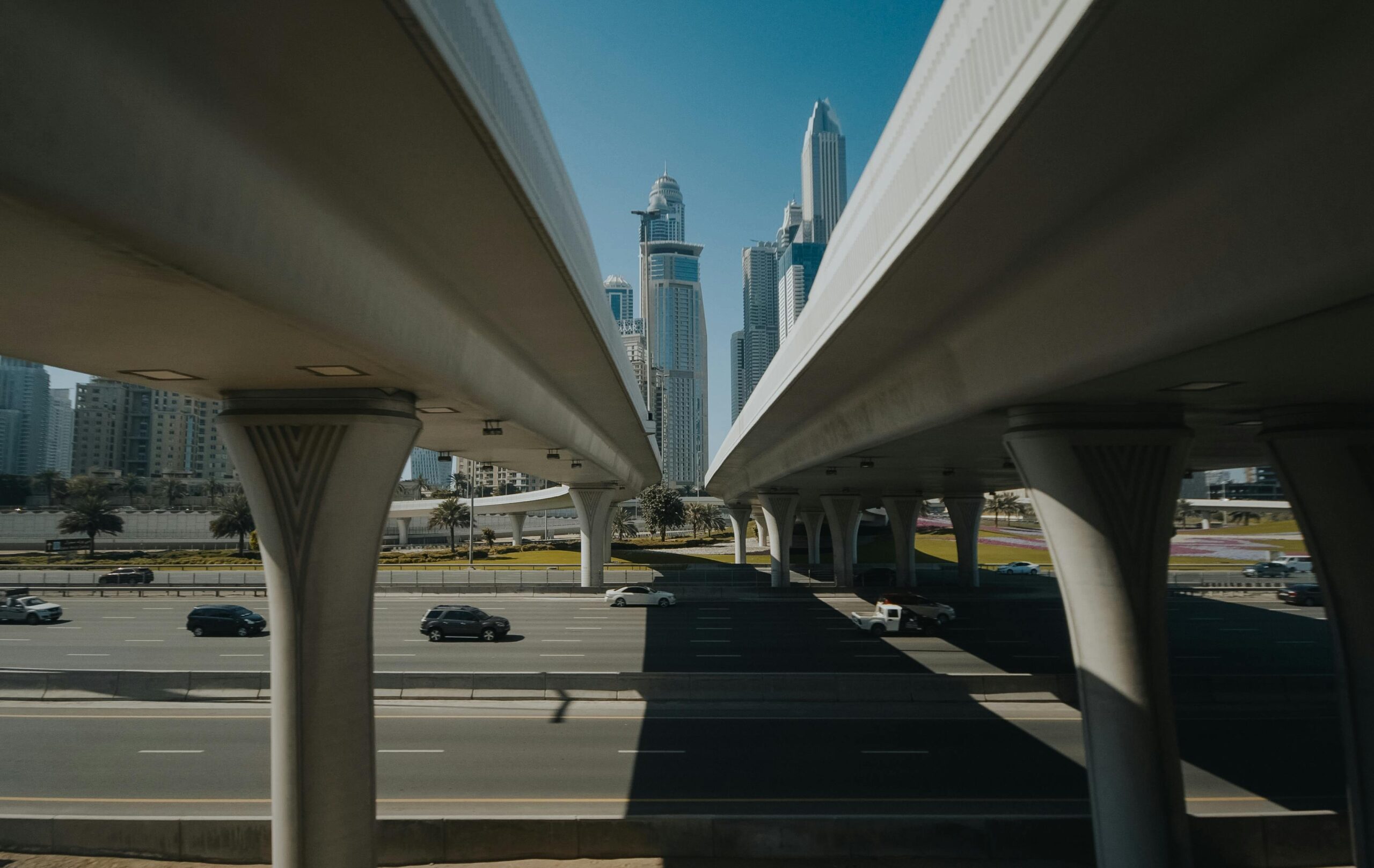 A dynamic aerial view of a futuristic cityscape featuring bridges, highways, and towering skyscrapers.